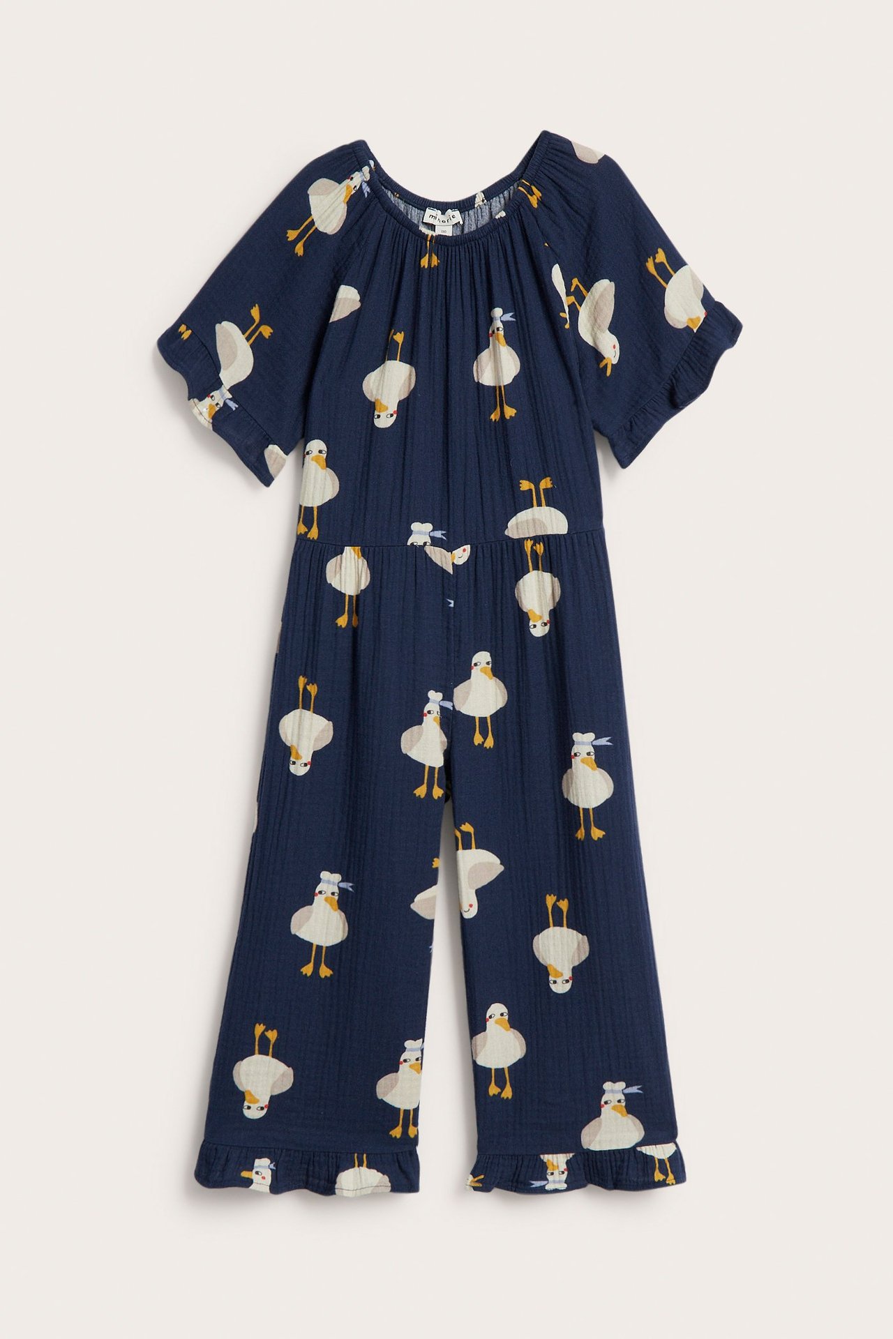 Lasten tummansininen puuvillahaalari ankkakuviolla, joustava pääntie, lyhyet hihat. Edestä.