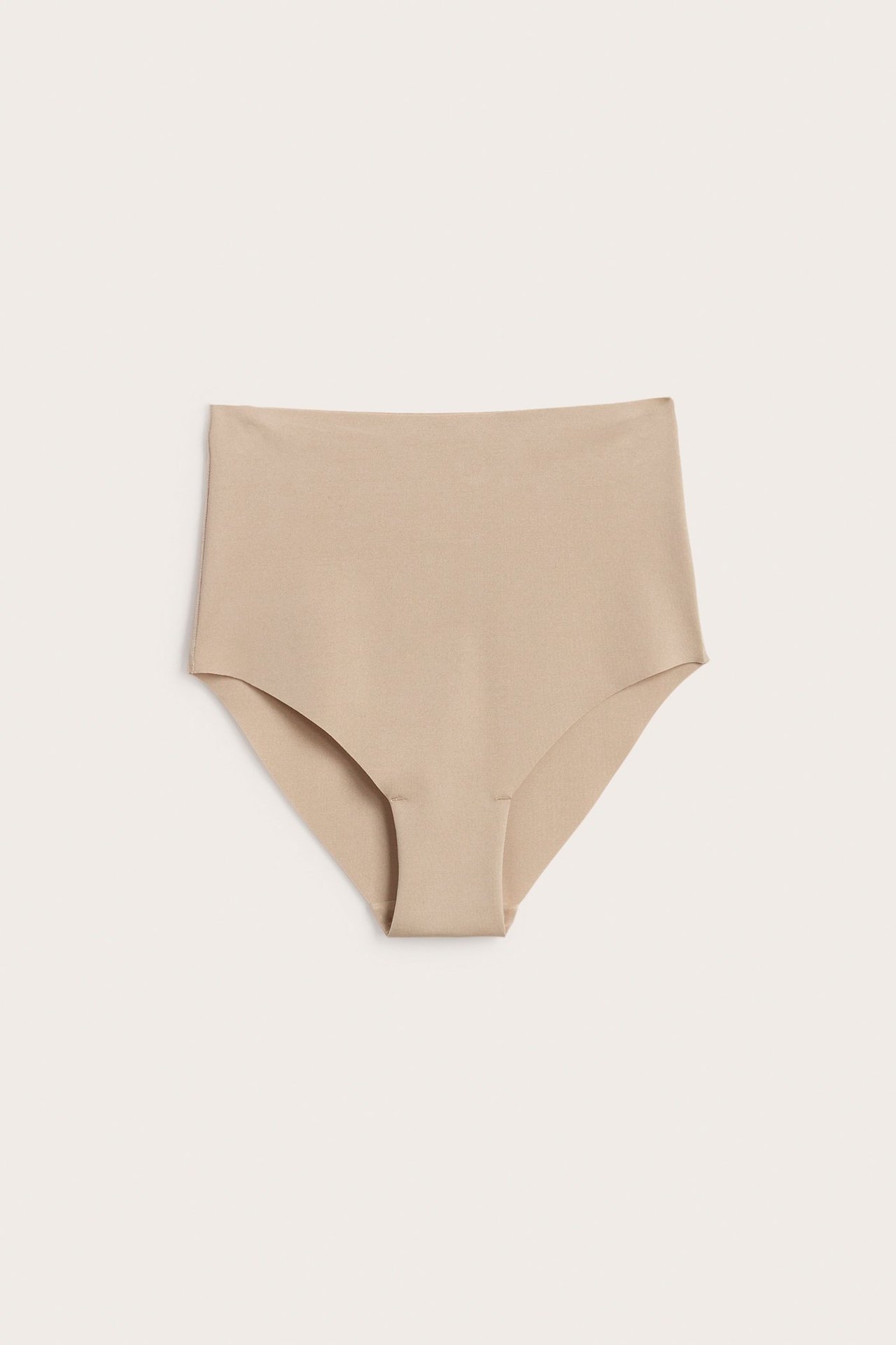 Edestä näkymä naisten ruskeista saumattomista korkeavyötäröisistä kevyistä muotoiluhousuista, sileät.