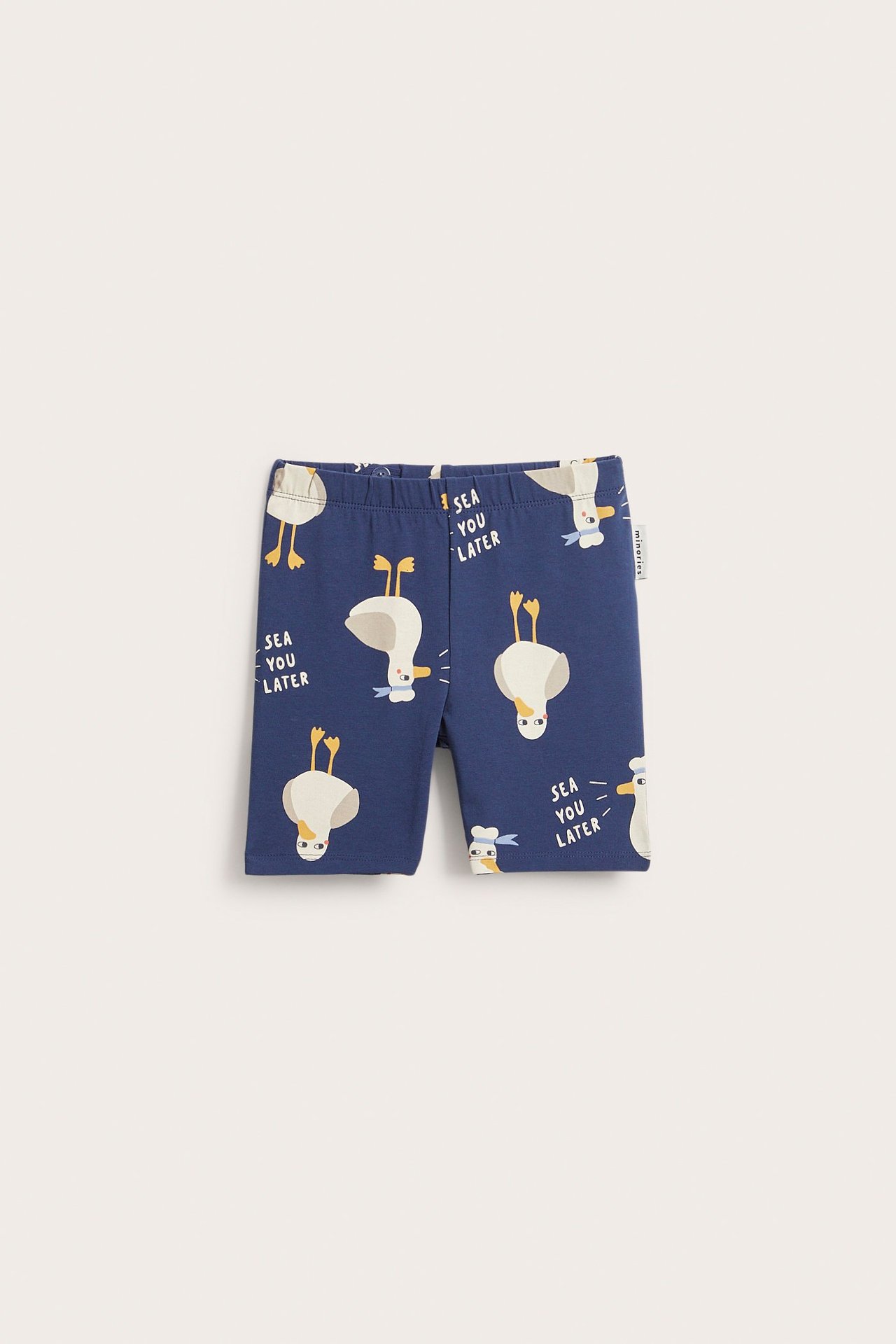 Framsida på barnens blå cykelbyxor med vitt ankprint och texten 'SEA YOU LATER'.