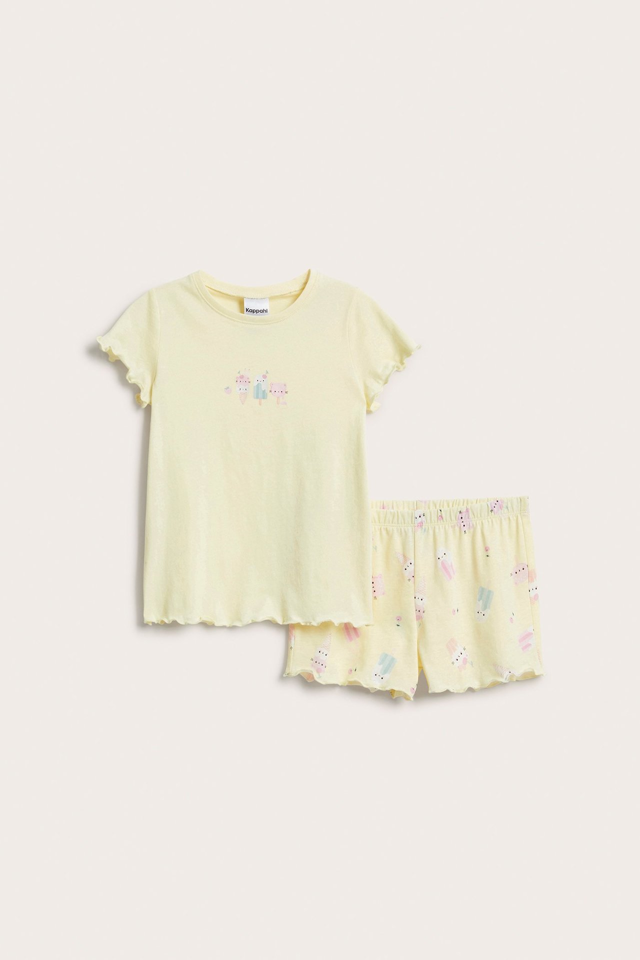 Widok z przodu: jasnożółta piżama dziecięca z bawełny z falbankami i nadrukiem lodów.