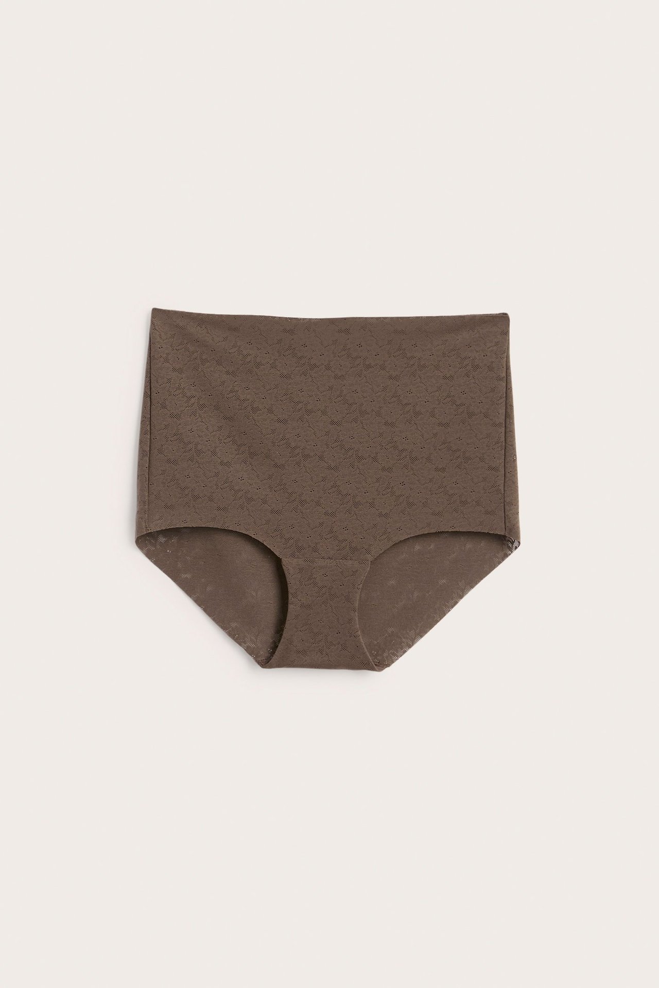 Framifrån, mörkbrun hipsterstrosa i stretchig spets med medelhög midja.