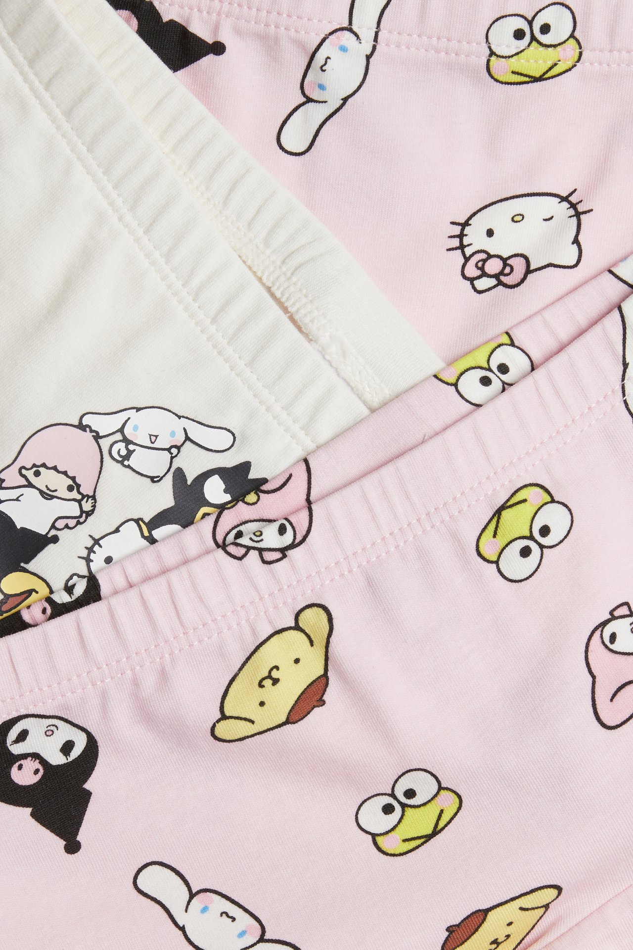 Zbliżenie na dziecięce bokserki w kolorze ecru i różowym z nadrukiem postaci Sanrio.