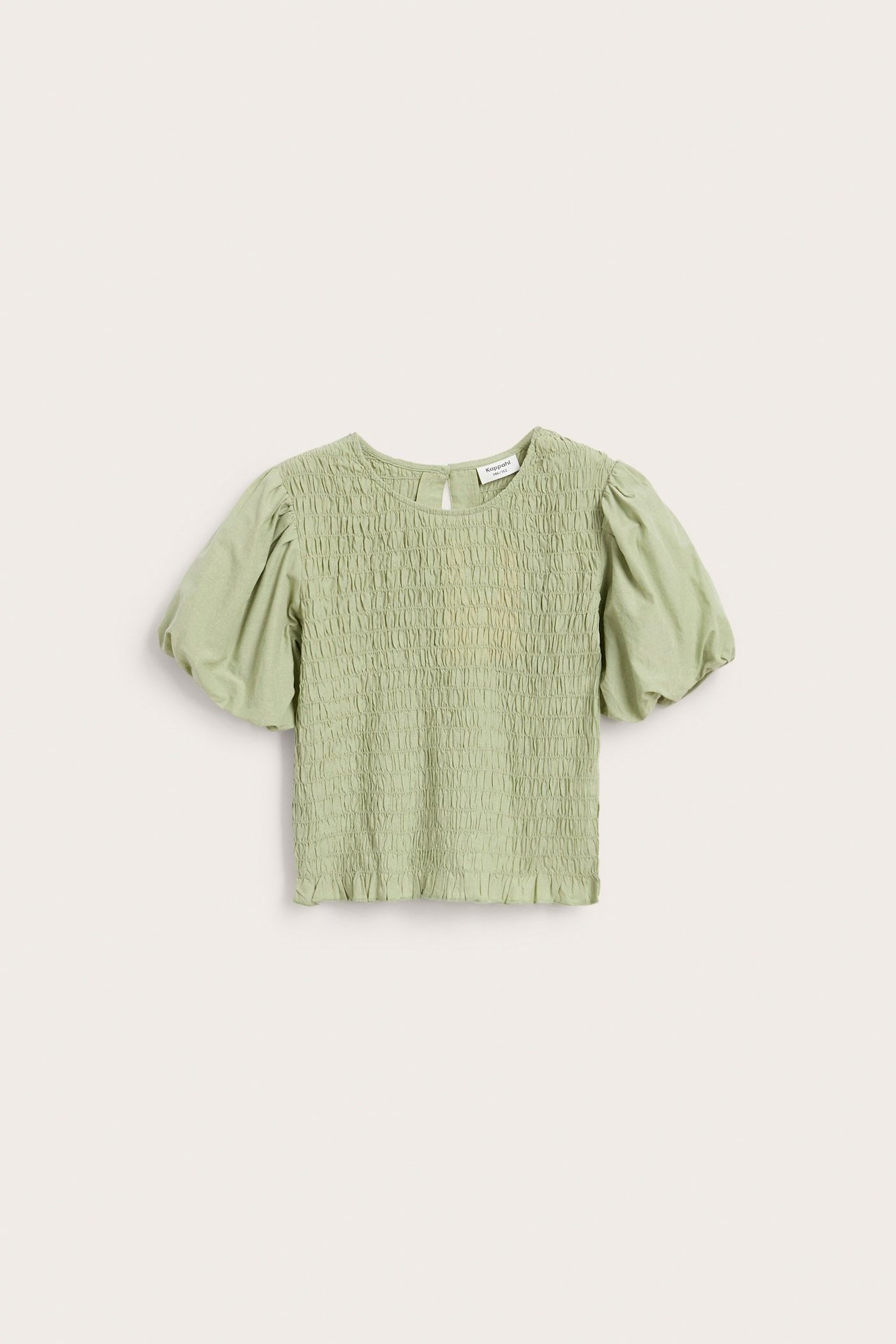 Framsida: ljusgrön bomullstopp med smock, puffärmar och knäppning bak.