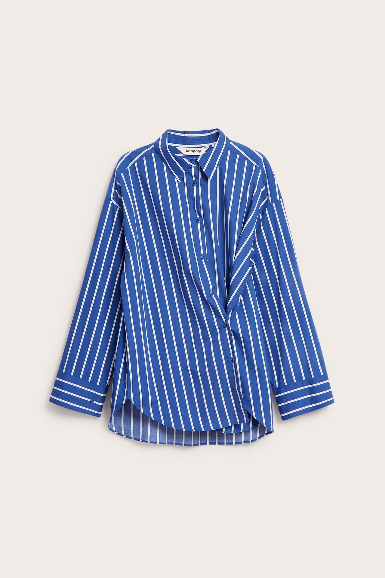 Frontbilde av en blå- og hvitstripet poplinskjorte med unik diagonal knappelukking og løs passform.
