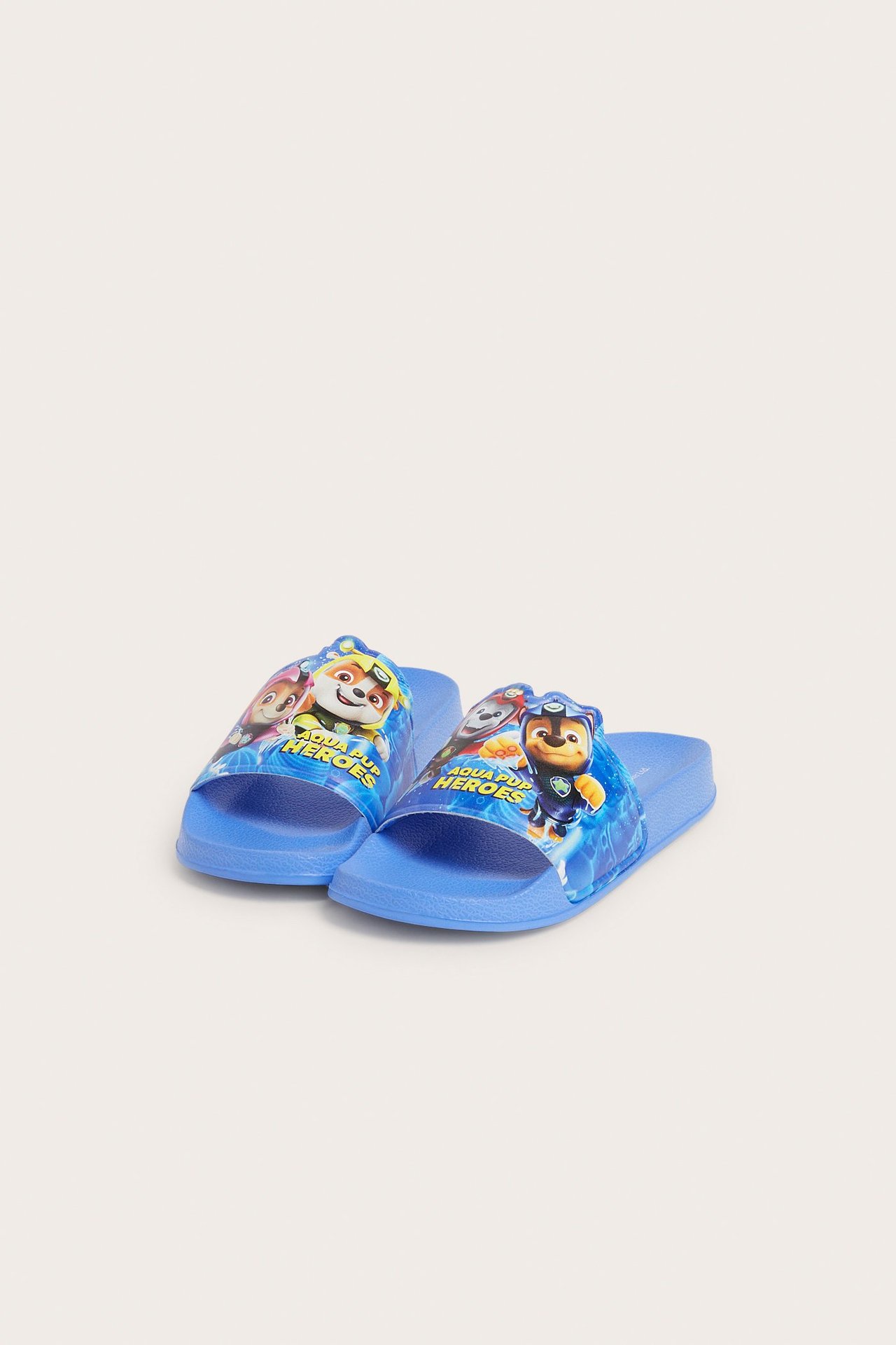 Widok z przodu niebieskich, plastikowych klapków kąpielowych Paw Patrol z nadrukiem na pasku.