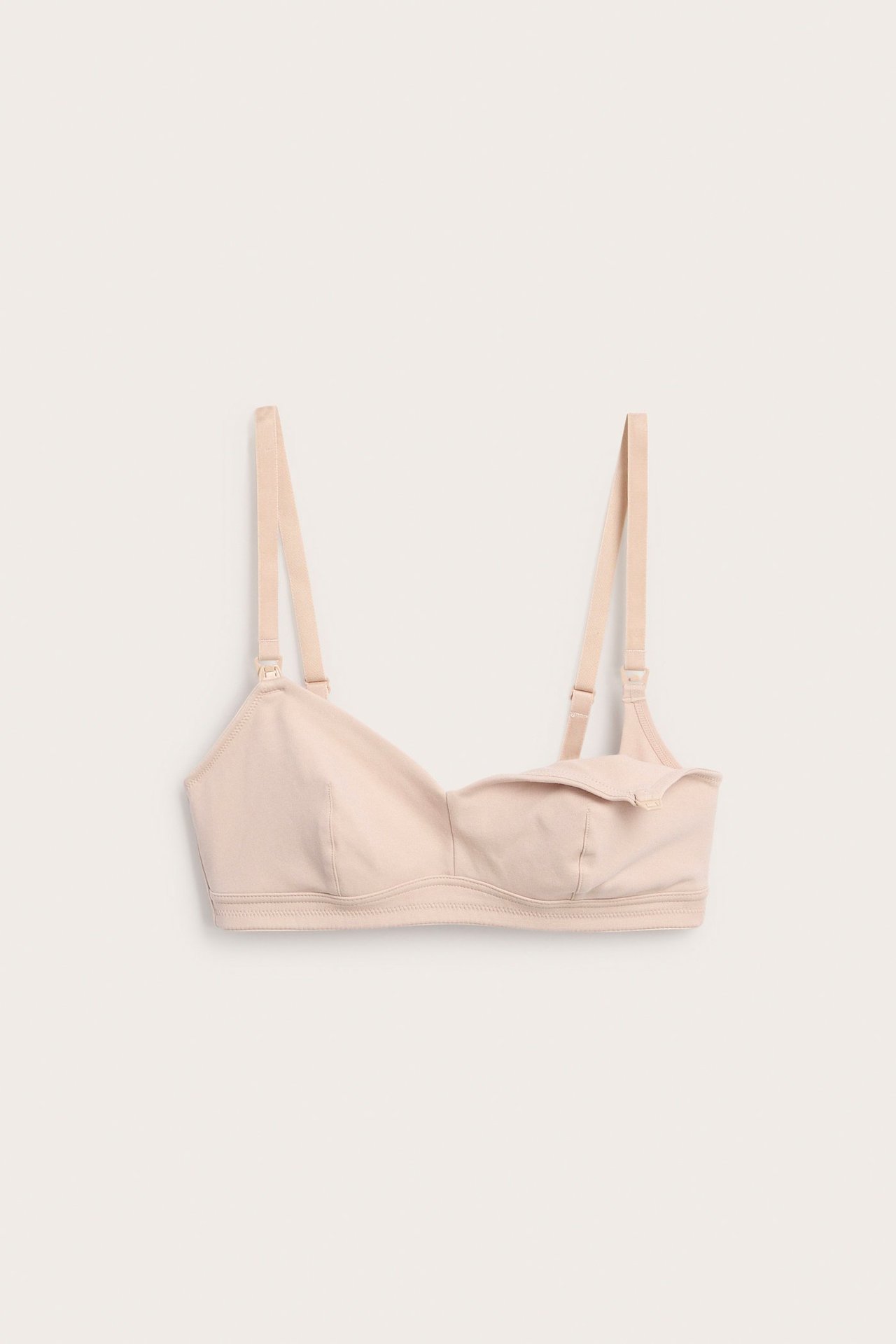 Edestäpäin, vaaleanpunainen, yksivärinen puuvillainen imetysliivi säädettävillä olkaimilla ja avatulla kupilla.