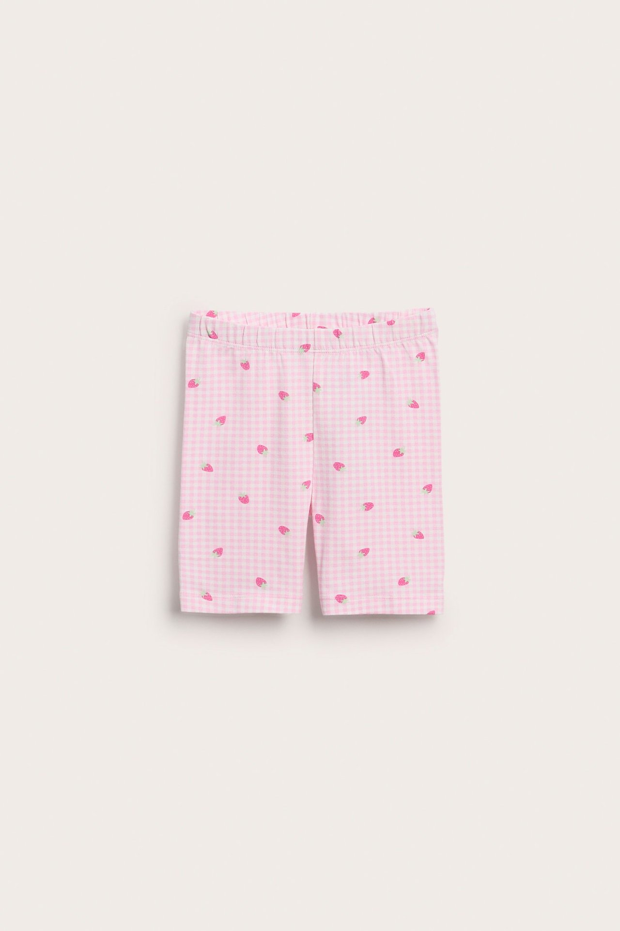 Przód: dziecięce jasnoróżowo-białe bawełniane szorty rowerowe w kratkę, z gumką i wzorem truskawki.