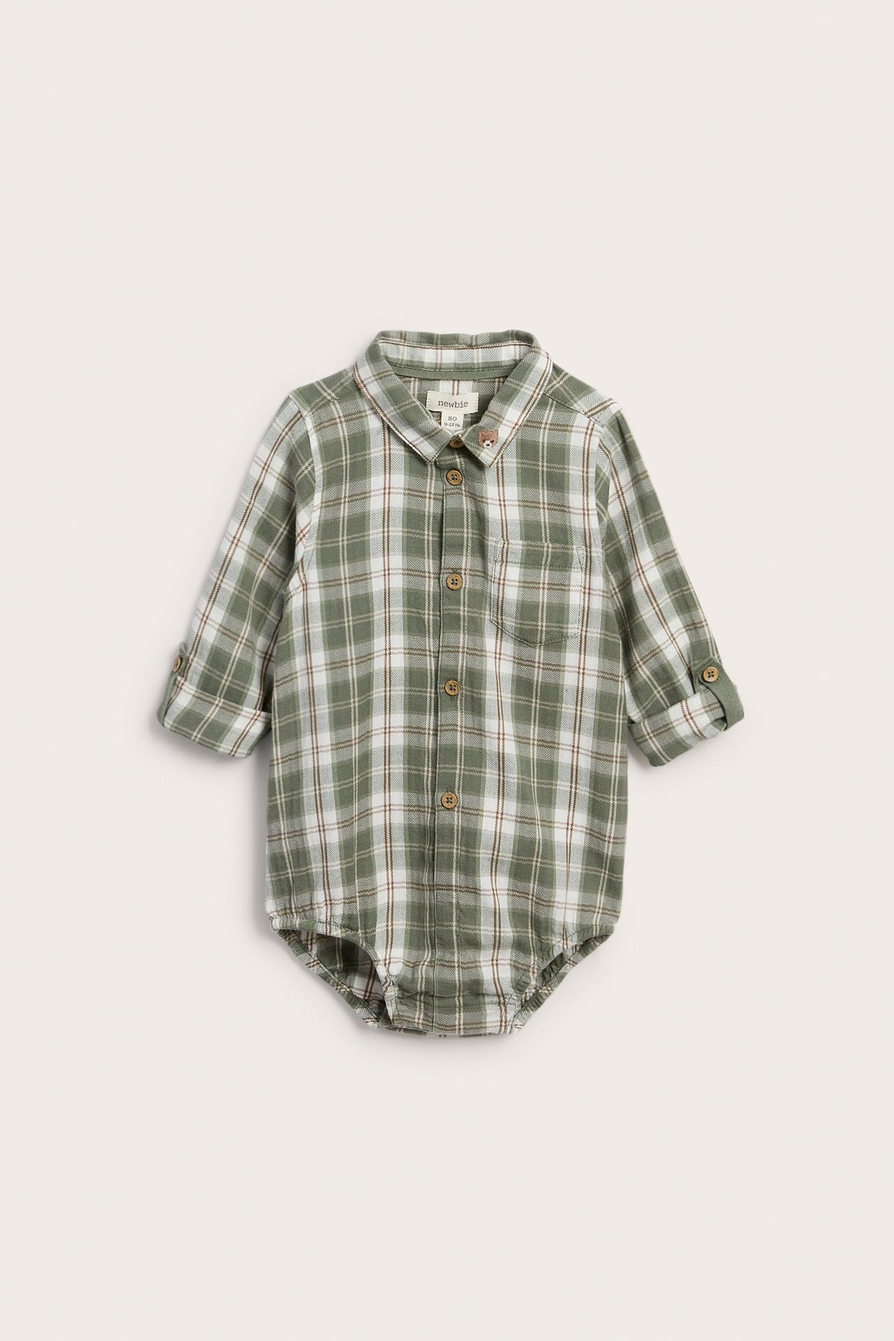Framifrån, babybody med lång ärm i grönt, vitt och brunt rutmönster, med knappar och björndetalj.