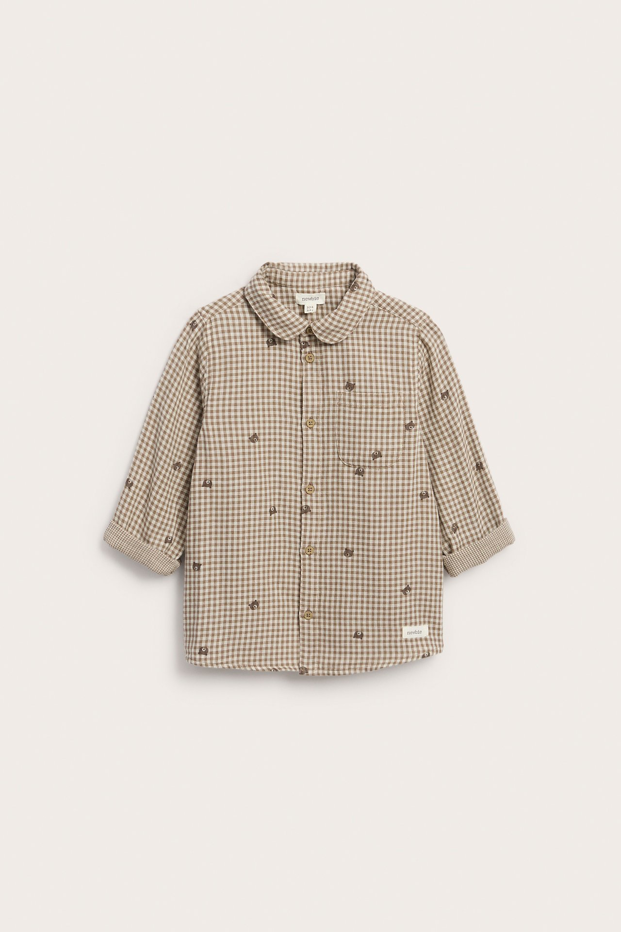 Edestä, ruskea-beige ruudullinen lasten paita brodeeratuilla karhuilla ja pyöreällä kauluksella.