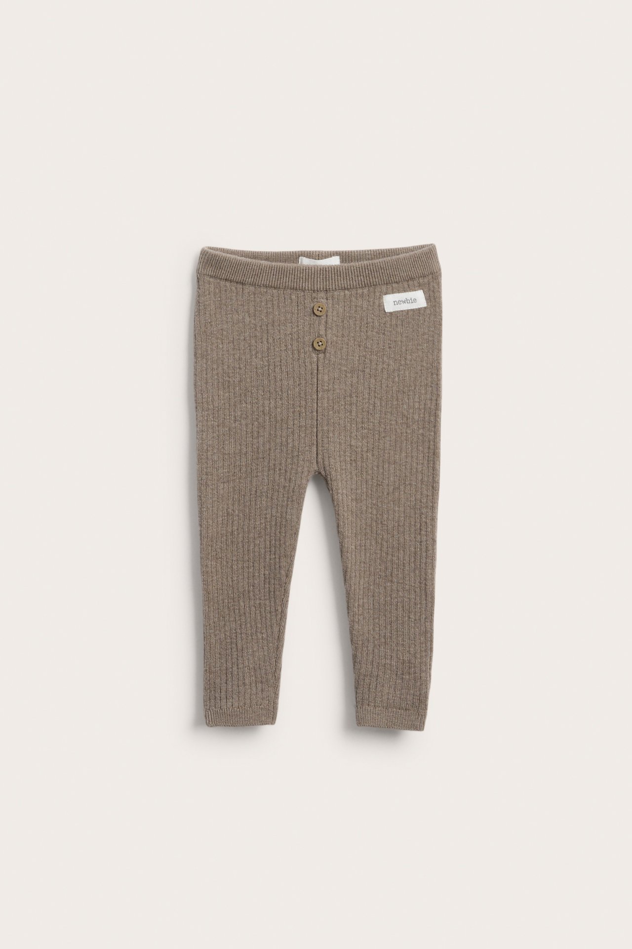 Frontvisning av ribbestrikkede brune babybukser med to knapper i midjen.