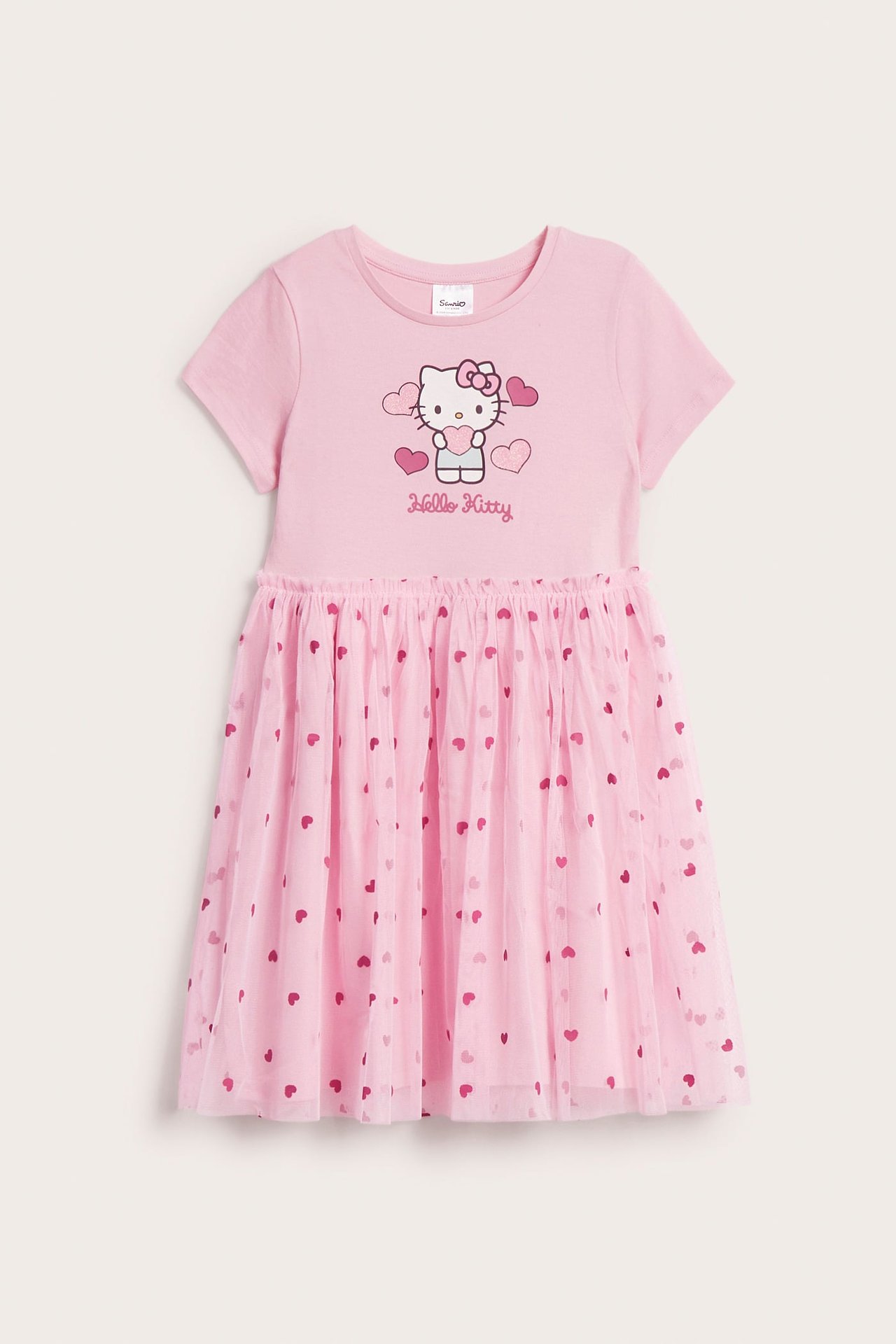 Widok z przodu: Różowa sukienka dziecięca Hello Kitty z krótkim rękawem i tiulową spódnicą w serca.