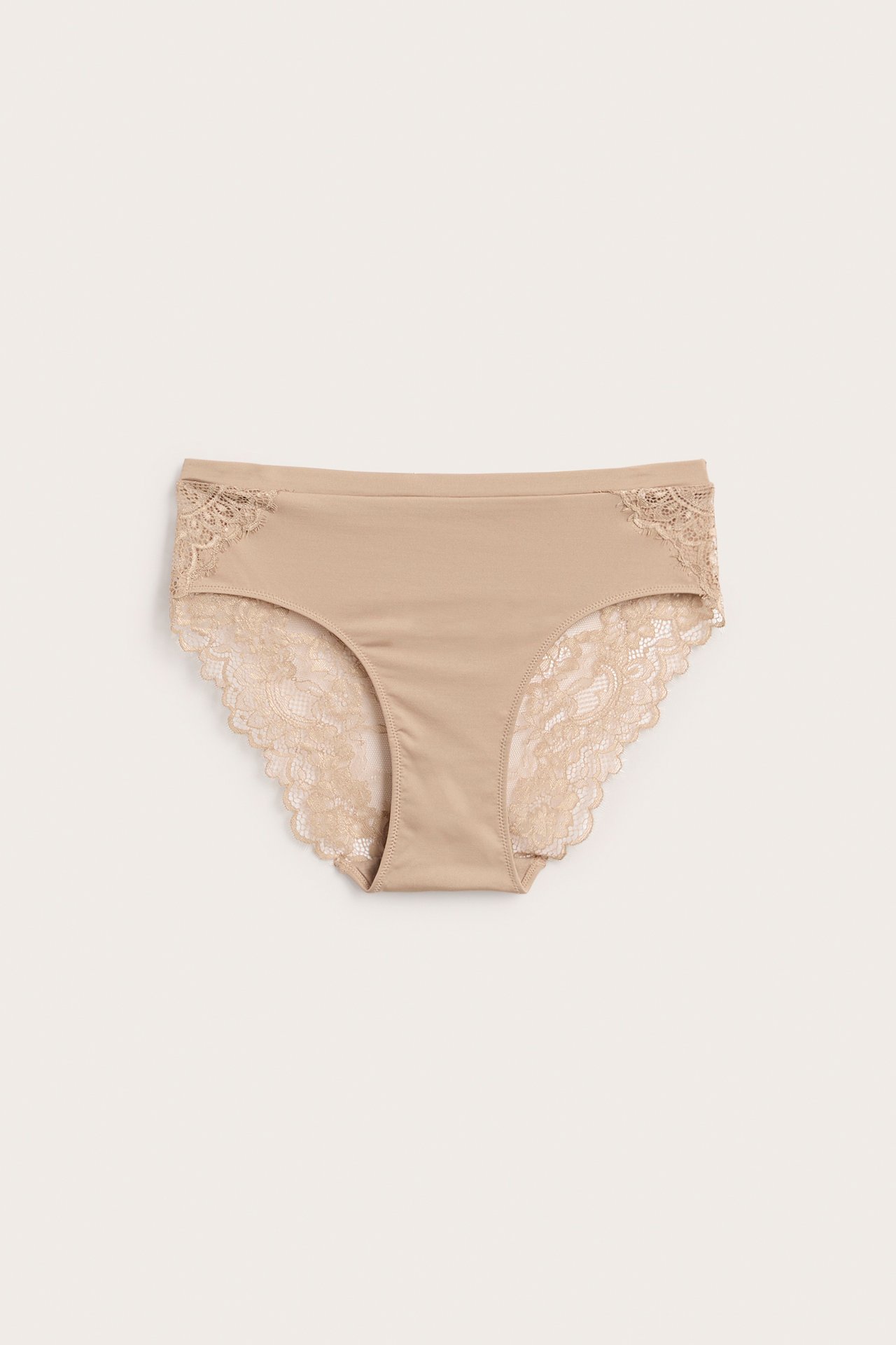Frontvisning av beigefargede dame-truse med blondedetaljer på sidene og benåpningene.