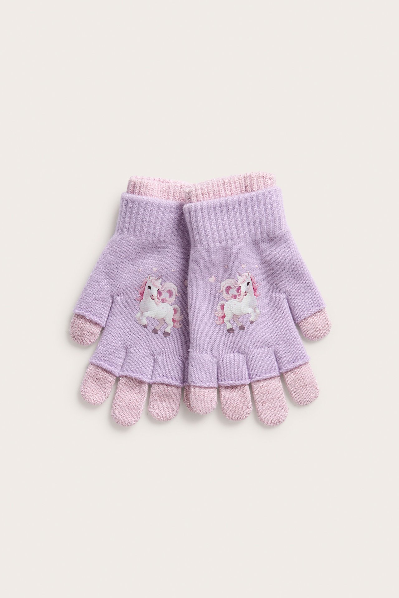 Ovenfra syn på lilla fingerløse barnehansker med rosa mansjetter og enhjørningstrykk.