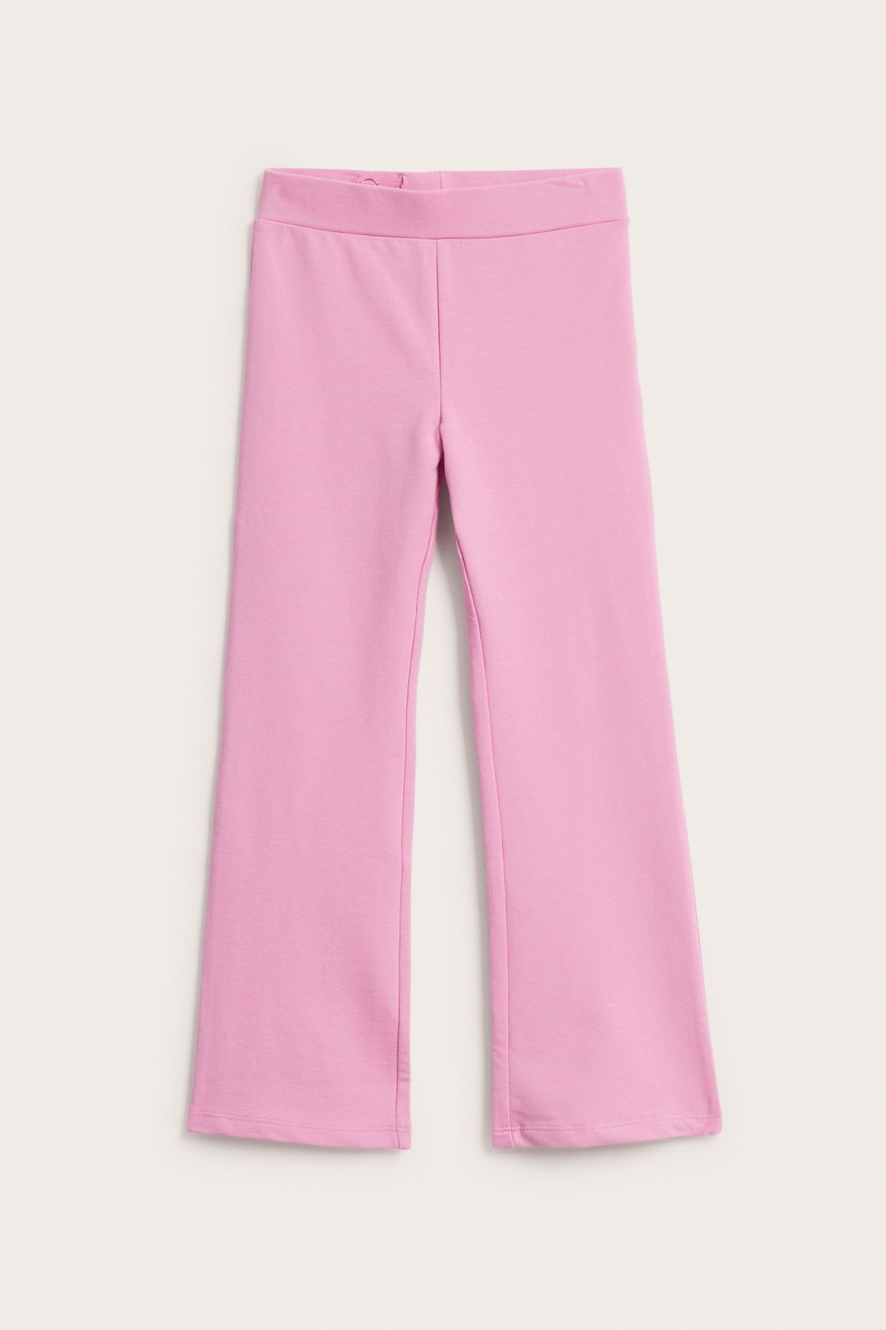 Edestä: vaaleanpunaiset levenevät leggingsit joustovyötäröllä.