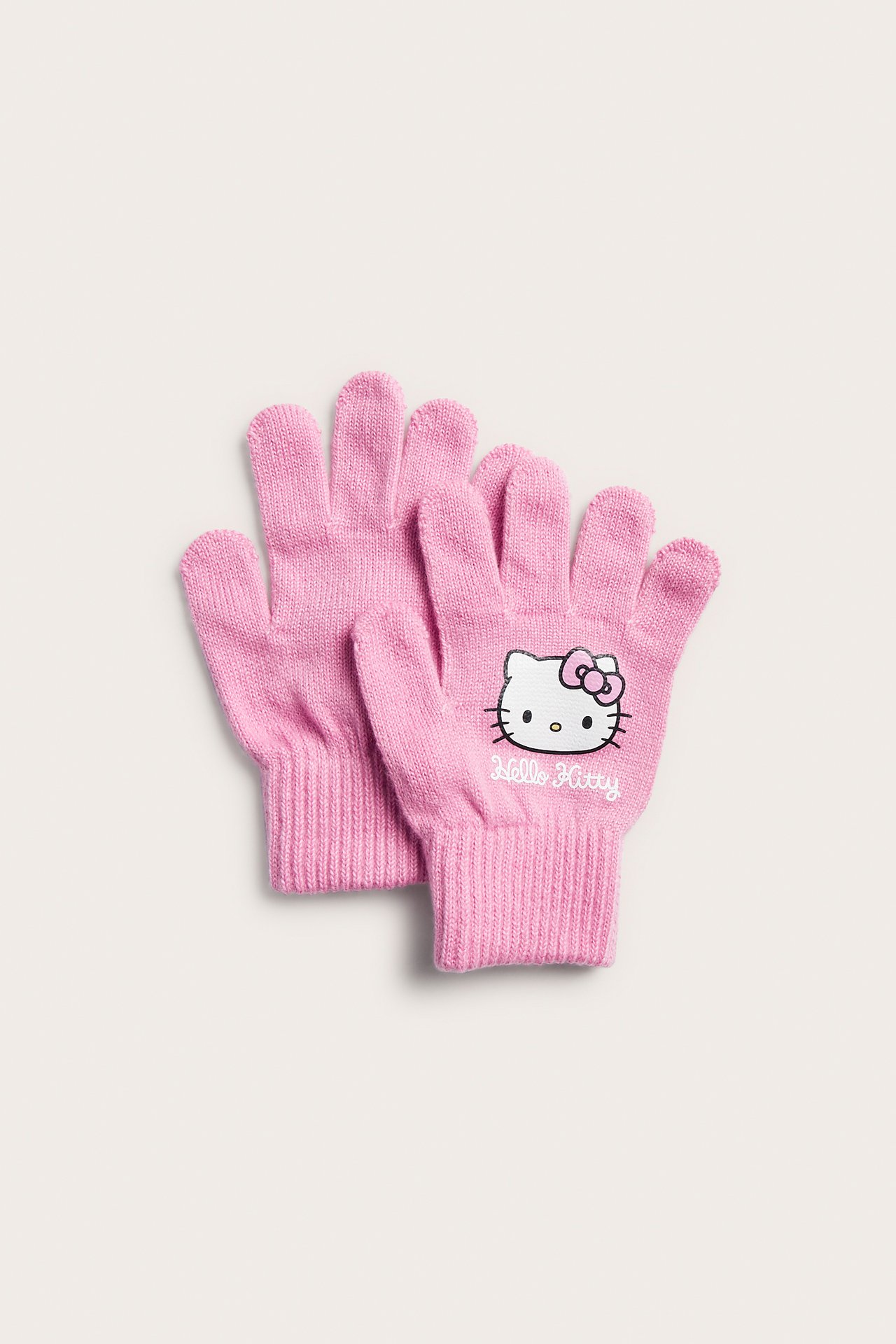 Widok z przodu dwóch różowych, dzianinowych rękawiczek Hello Kitty.