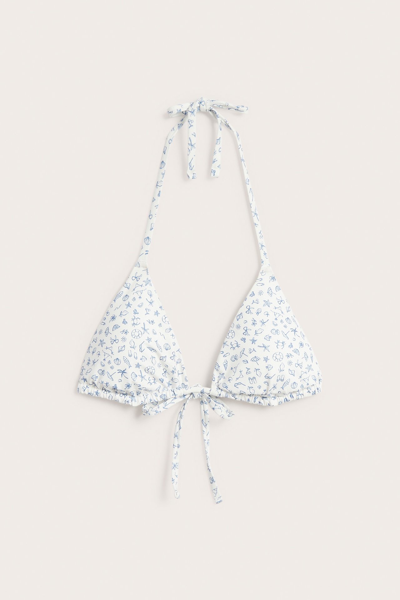 Edestä kuvattu offwhite toppattu kolmiobikiniyläosa sinisellä kesäkuviolla ja solmukiinnityksillä.