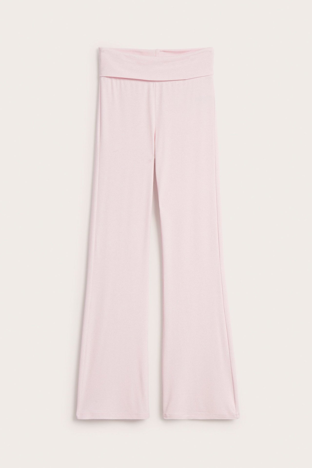 Framsida av ljusrosa utsvängda leggings med bred, nedvikbar midja.