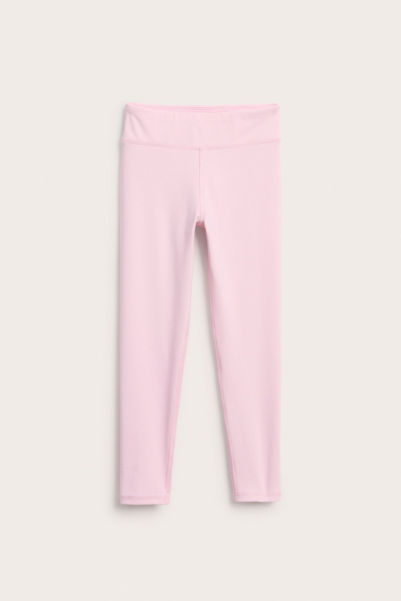 Frontvisning av ensfargede rosa stretchige jersey-treningsleggings.