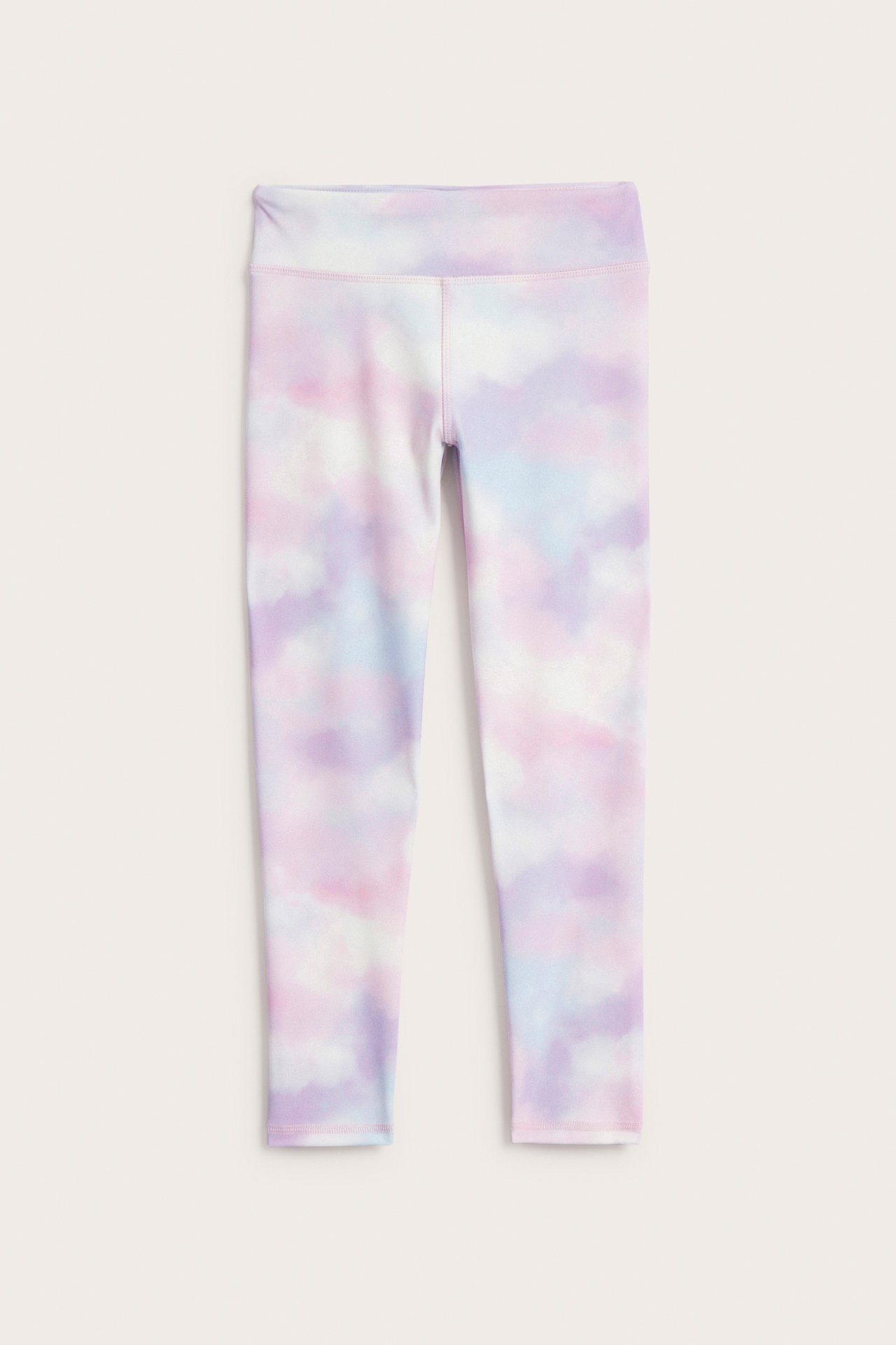 Edestä kuvattuna lasten offwhite tie dye -treenileggingsit vaaleanpunaisella, sinisellä ja violetilla painatuksella.