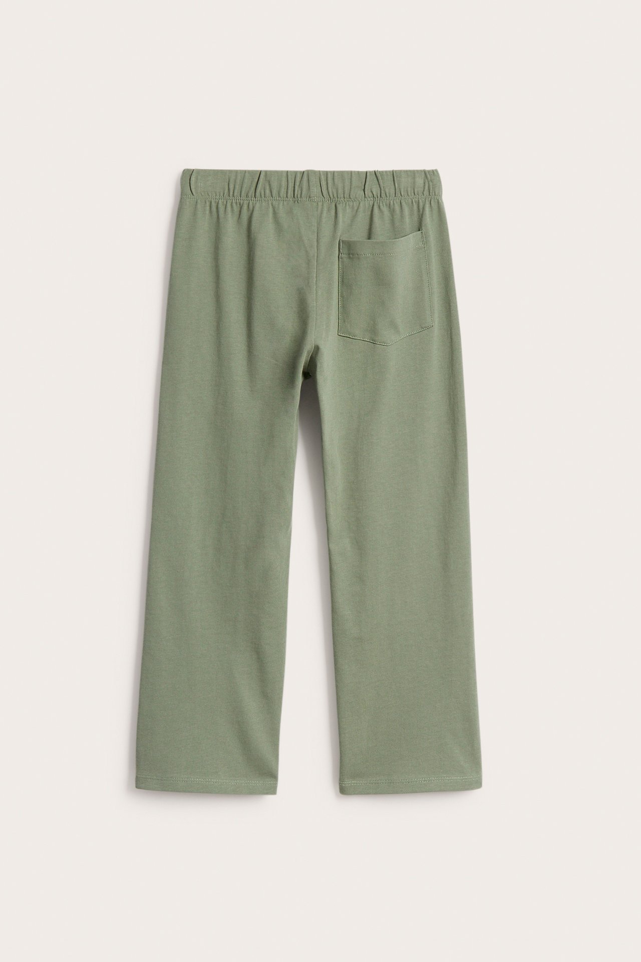 Takakuva: Tummanvihreät lasten puuvillatrikoo-collegehousut, suoralahkeiset, joustovyötärö ja takatasku.