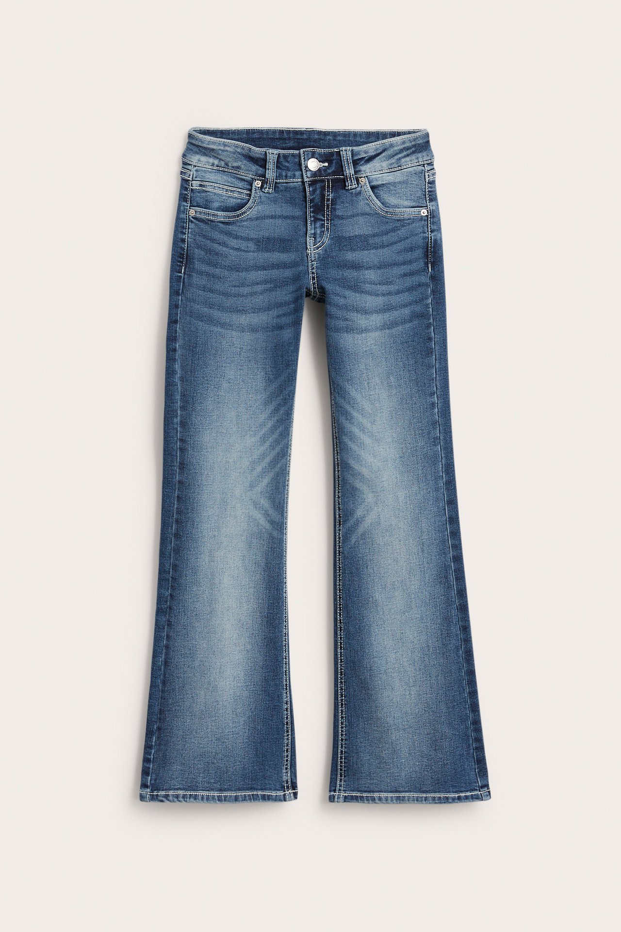 Edestäpäin lasten matalavyötäröiset deniminsiniset bootcut-farkut napilla ja etutaskuilla.