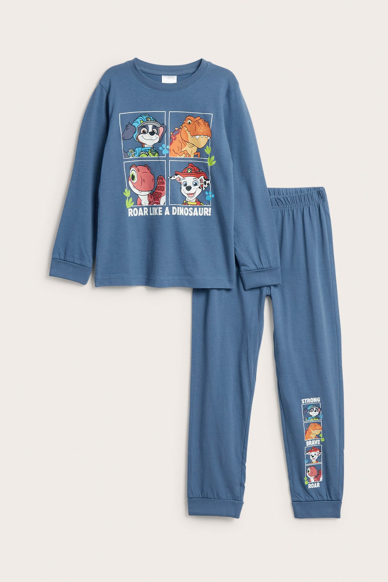 Framifrån: blå pyjamas i bomull med Paw Patrol Dino-tryck för barn, med muddar vid ärm- och benslut.