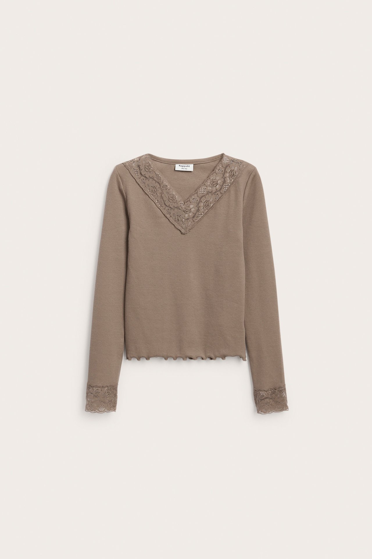 Forfra: Brun langermet jerseytop med blonde V-hals og bølget nederkant.