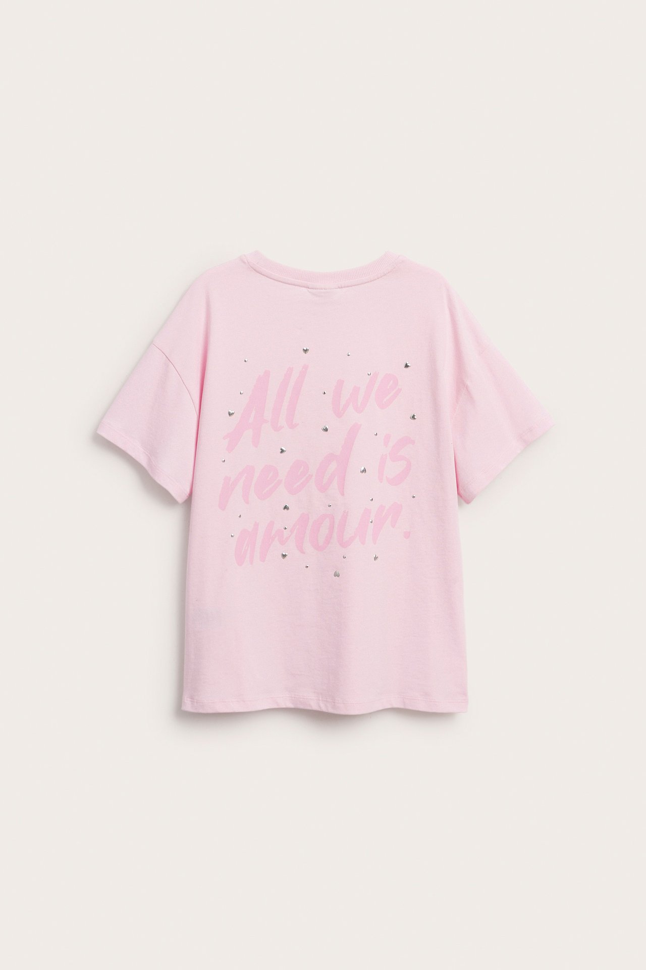 Rosa kortärmad T-shirt i bomull för barn med texten "All we need is amour." och strass baktill.