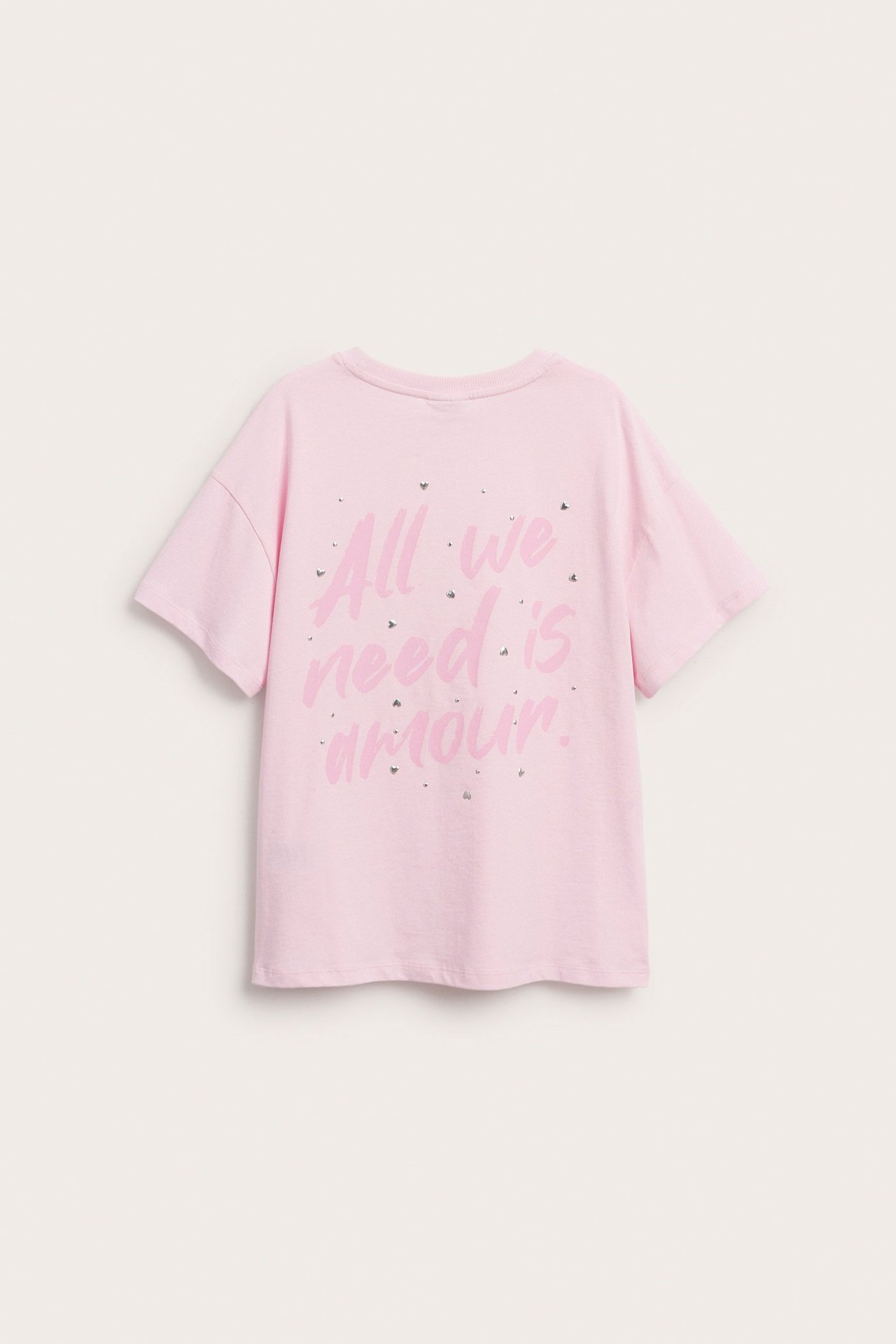 Rosa kortärmad T-shirt i bomull för barn med texten "All we need is amour." och strass baktill.