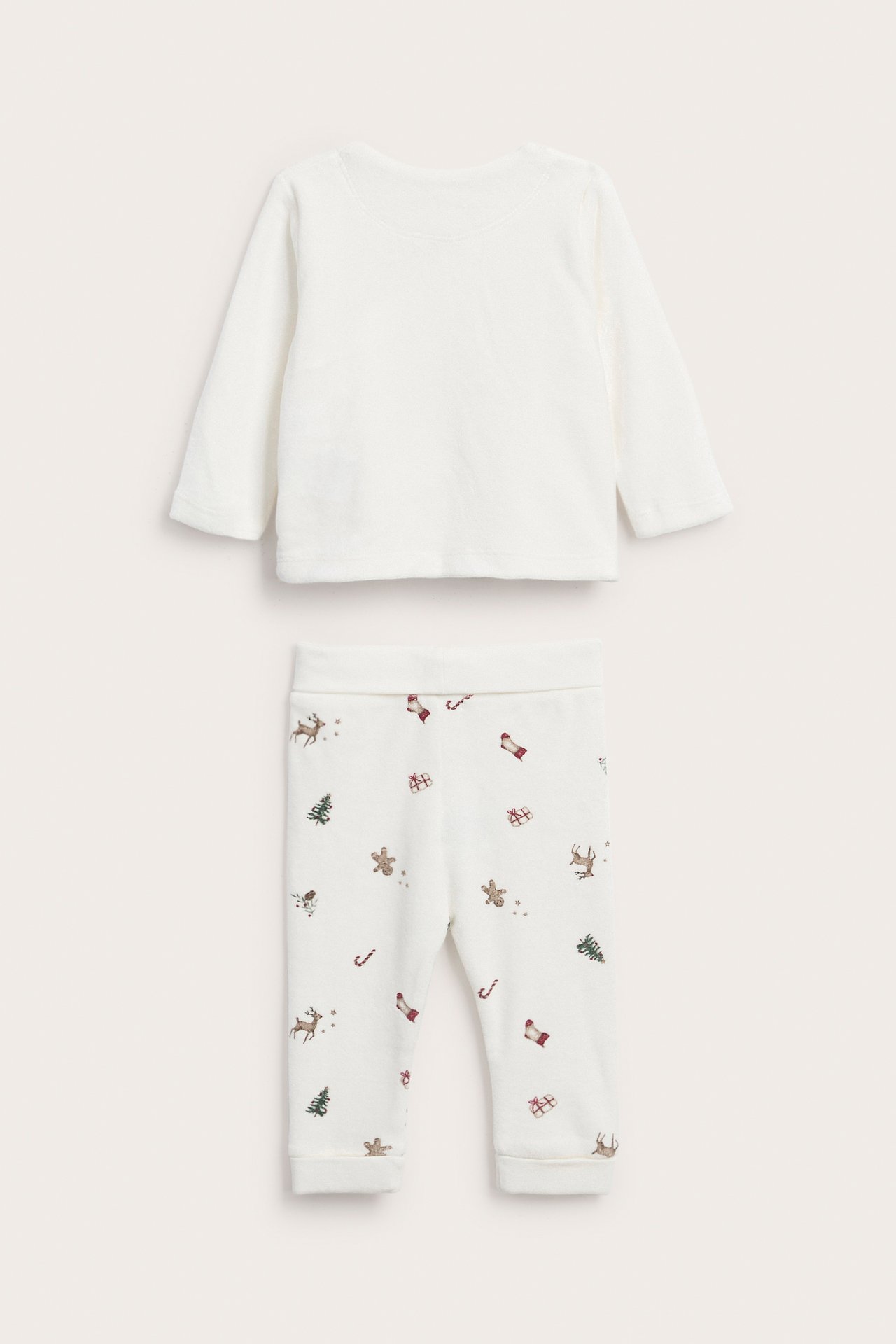 Frontvisning av et hvitt baby kosesett med en ensfarget langermet topp og mønstrete juleleggings.