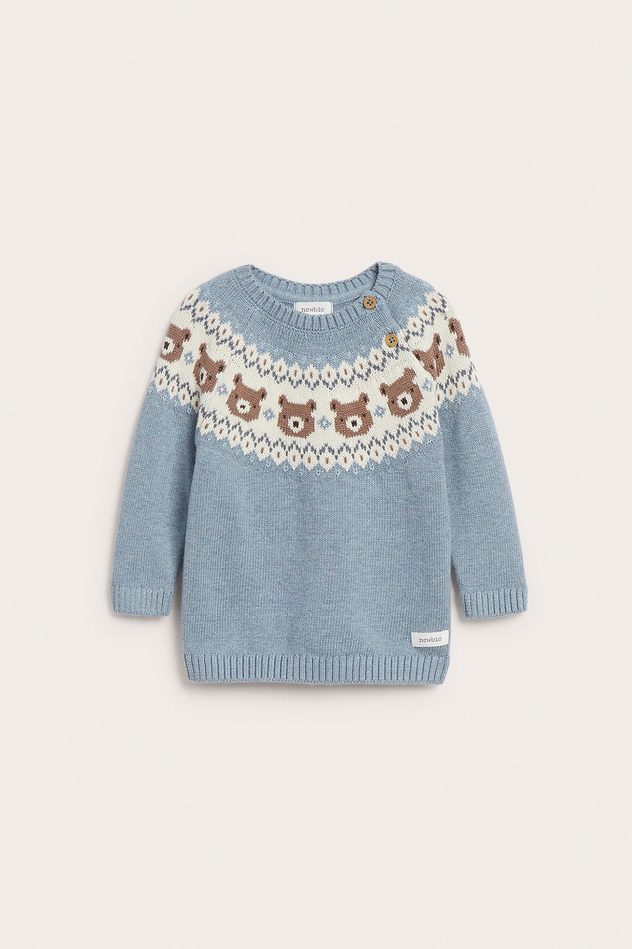 Edestä näkymä vauvan sinisestä neulepuserosta, jossa Fair Isle -karhumuotoja ja kaksi nappia.
