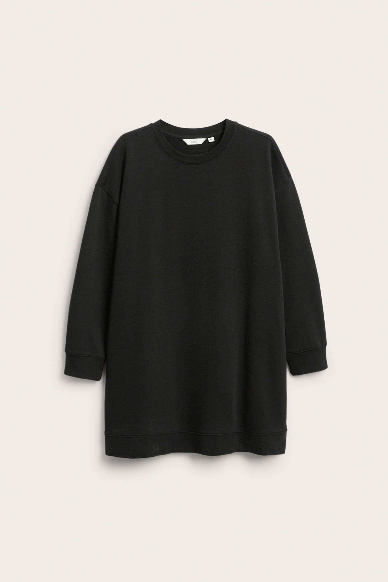 Widok z przodu czarnej, długiej bluzy oversized z okrągłym dekoltem oraz prążkowanymi mankietami i dołem.