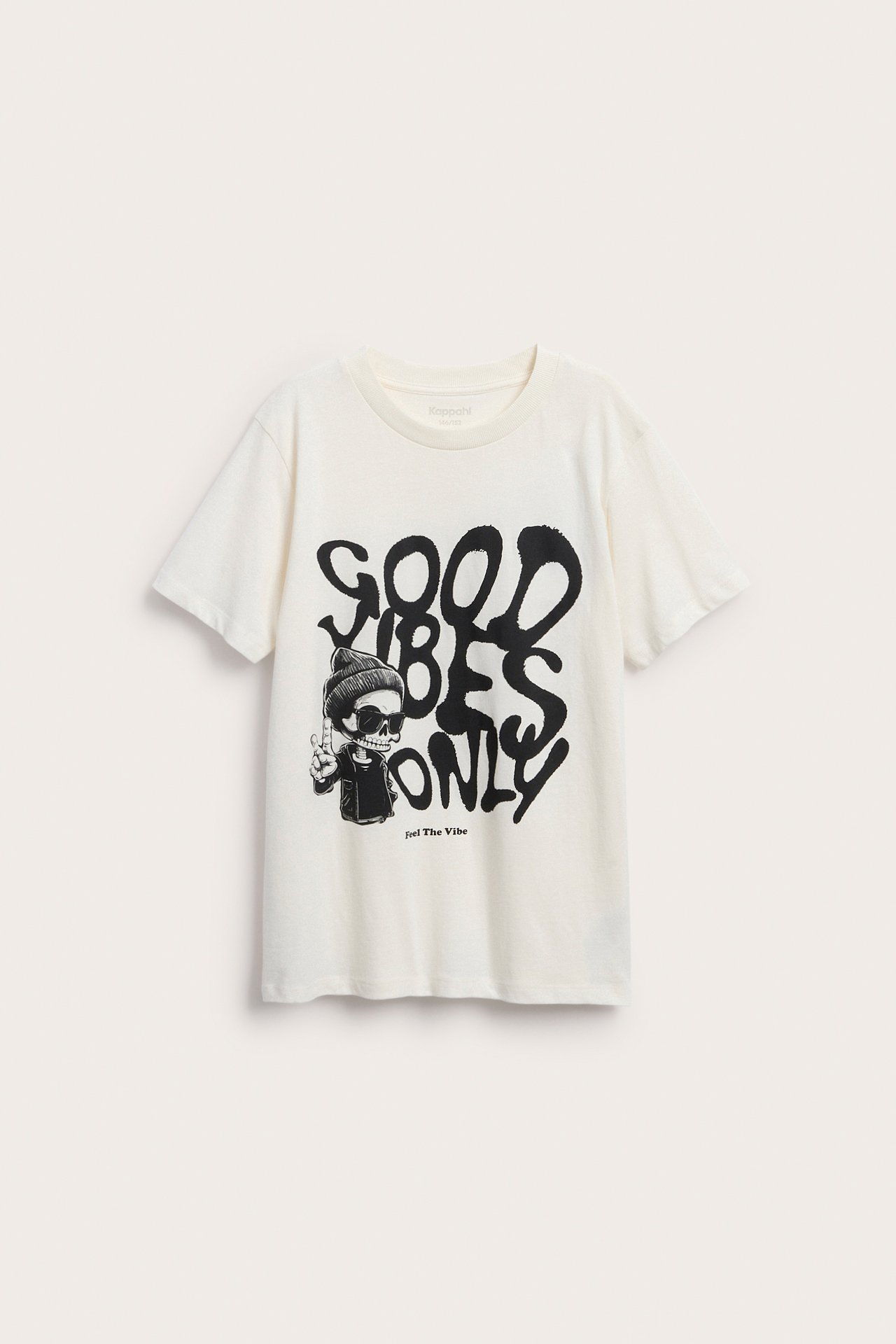 En barn-t-shirt i krämvitt med ett grafiskt tryck av skelett och "GOOD VIBES ONLY".