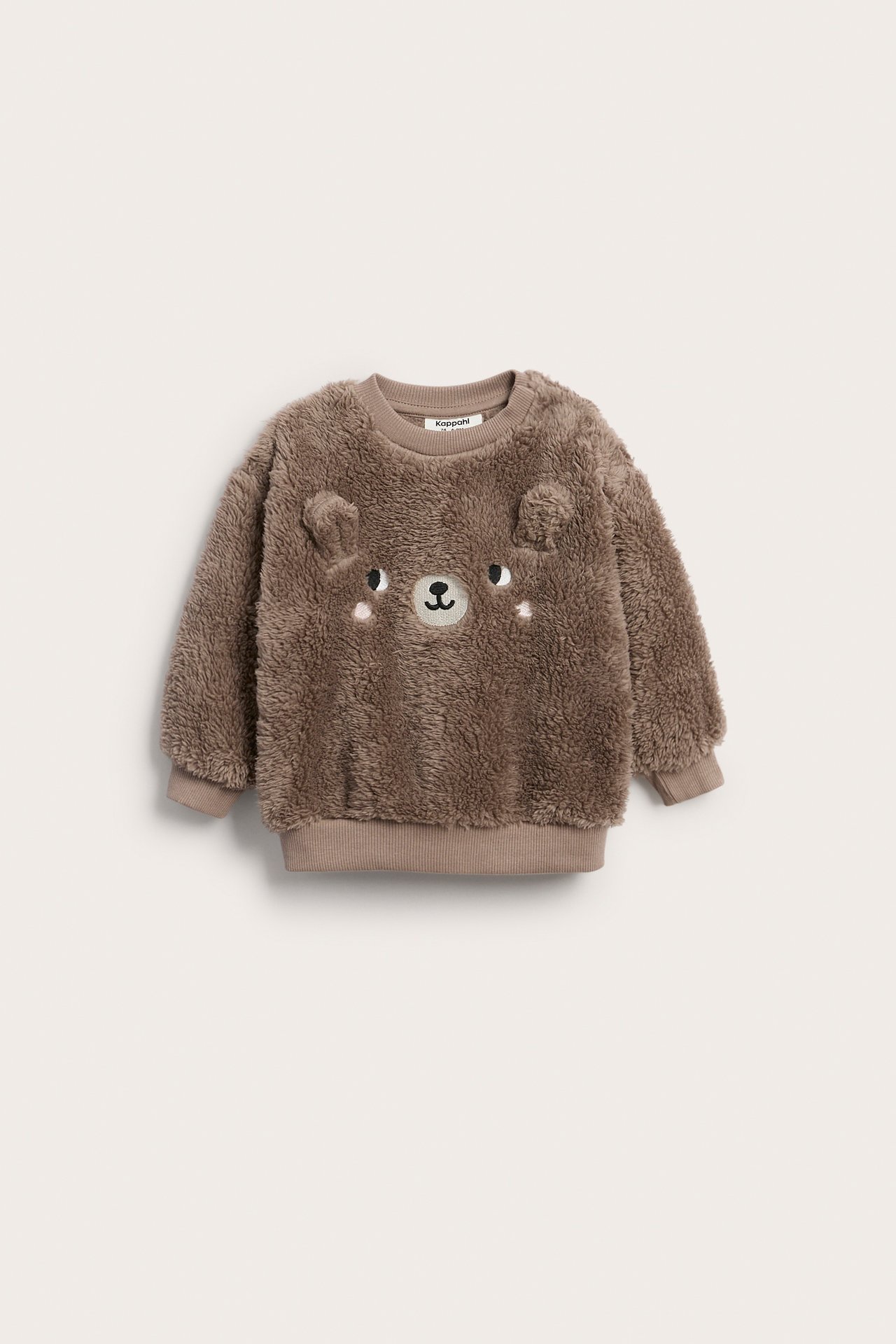 Framifrån, brun fluffig babymjukiströja med björnansikte och 3D-öron.