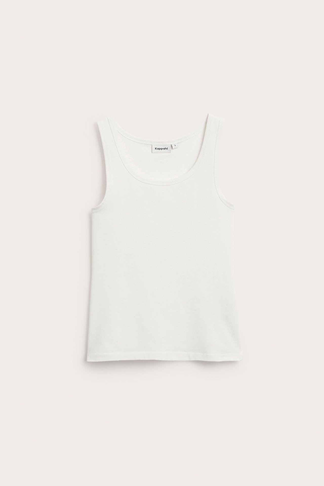 Edestä kuvattu valkoinen joustava puuvillatrikootoppi.