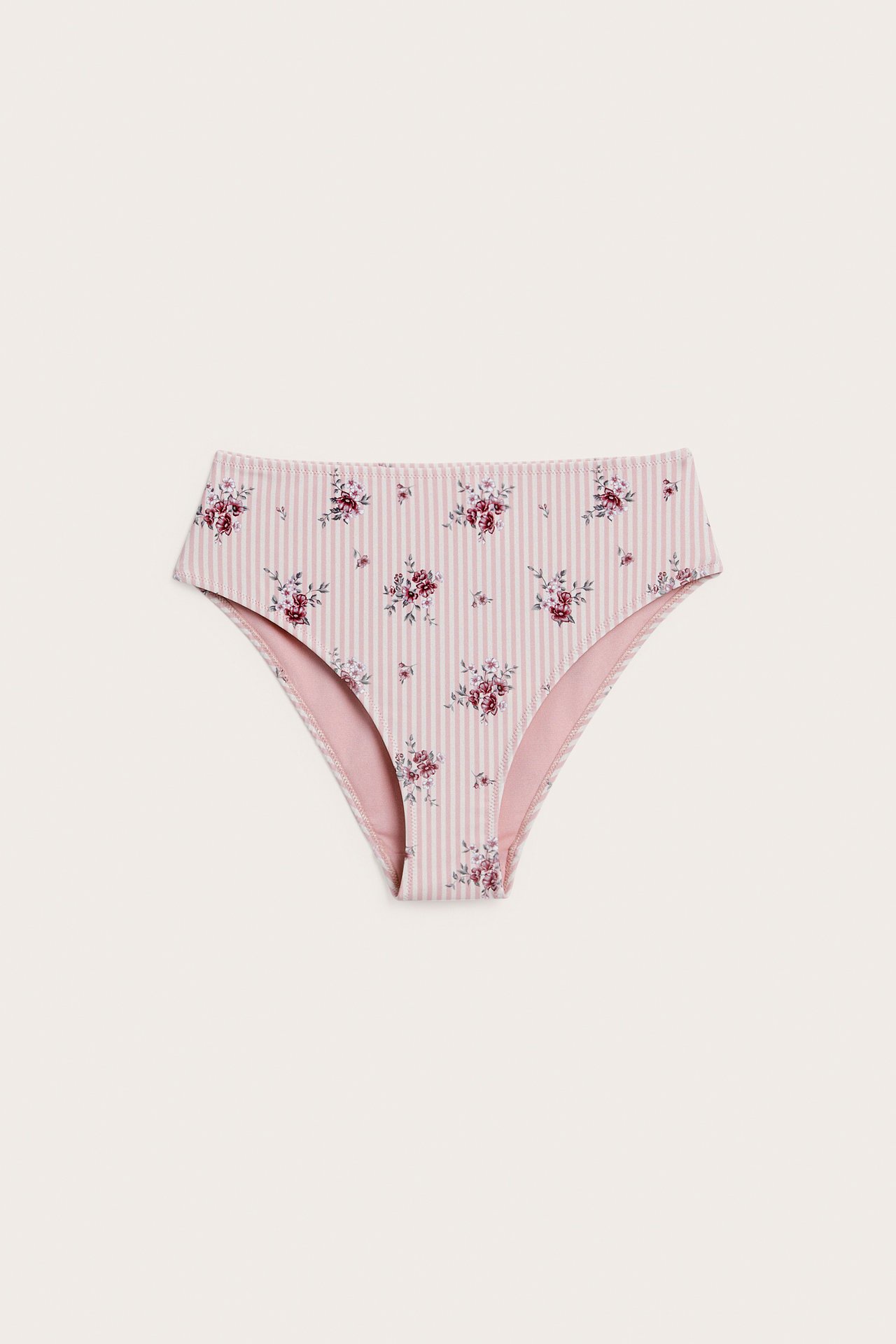 Frontvisning av høytrusetruse for dame med rosa-hvite striper og blomstertrykk.